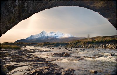 The river Sligachan with Black Cuillin in the background under the old stone bridge.