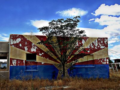 Fading Arizona flag on abandoned building