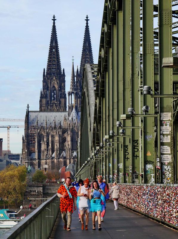 Koln; the cathedral, the bridge and carnival costumed people. 
