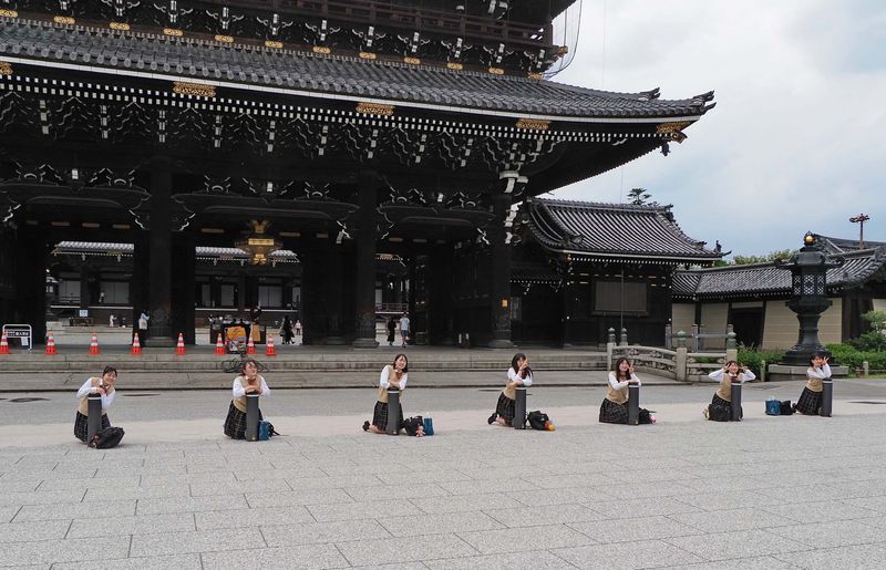 Kyoto; students playing in front of the Higashi-Honganji Temple.