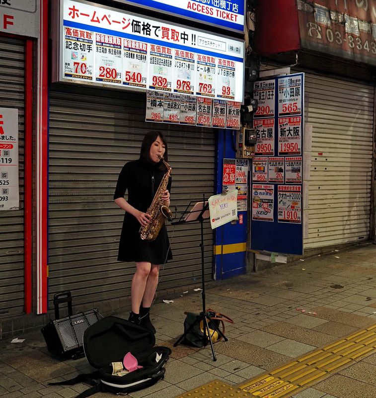 And a charming girl playing saxophone near the station.