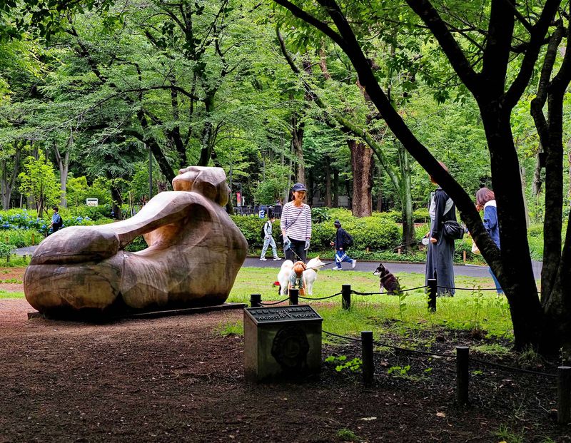 People walking their dogs in the park.