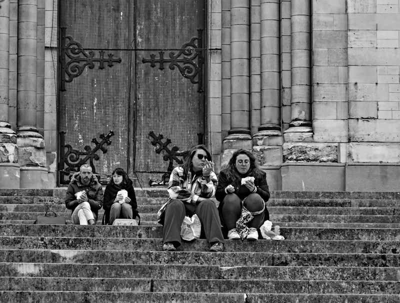20me; people resting at church stairs.