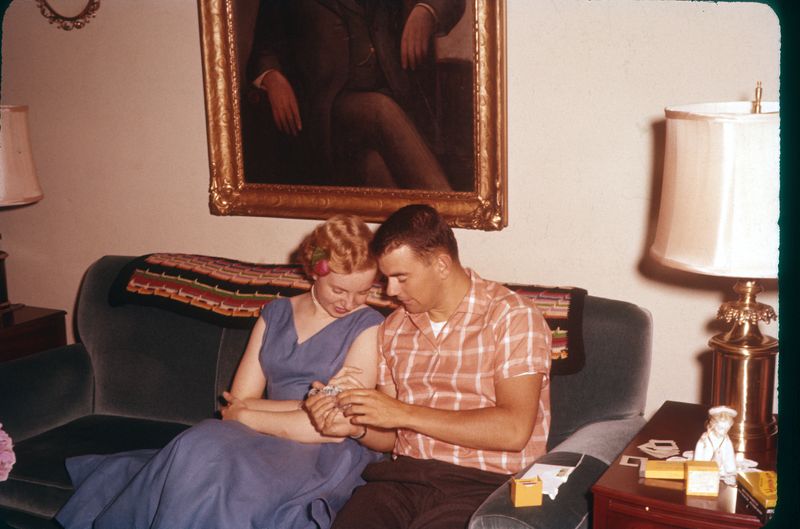 Joanne & Ted looking at slices, Gramps portrait in back