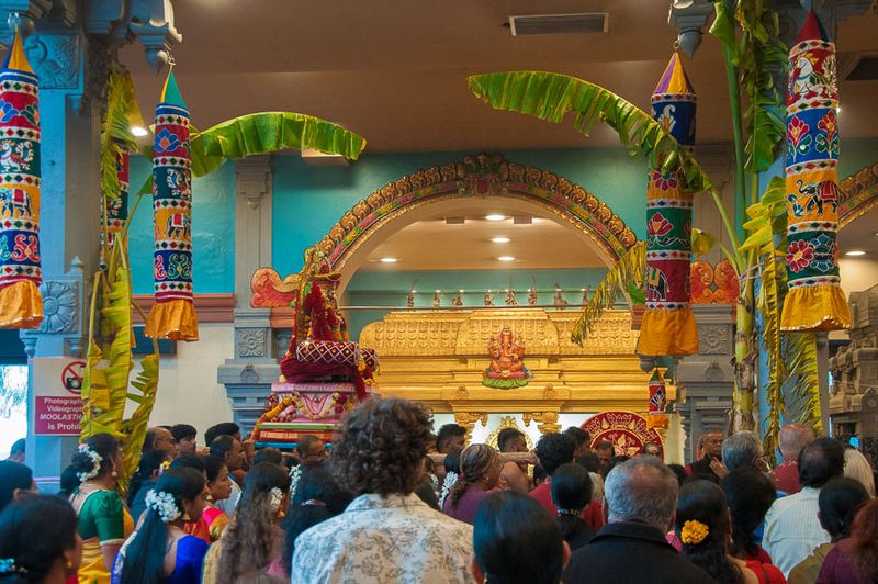 Worshippers await the priests' preparation of the deity