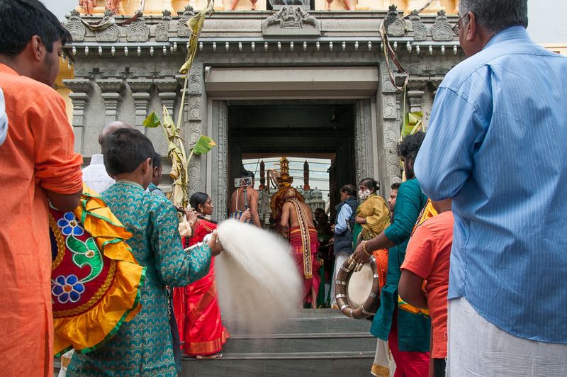 The deity is conveyed outside from within the temple