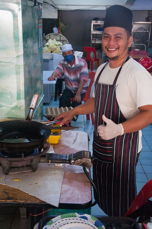 Cheerful short-order cook at Sibu, Sarawak