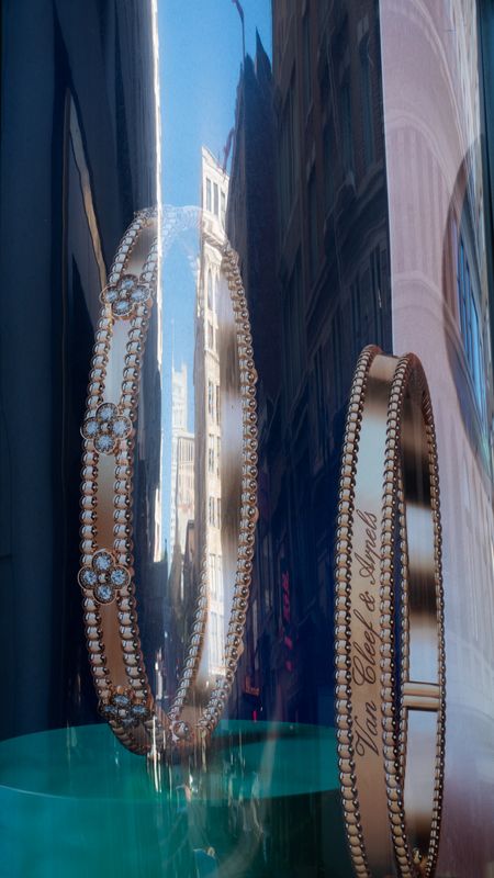 Van Cleef & Arpels ad reflection on Powell Street