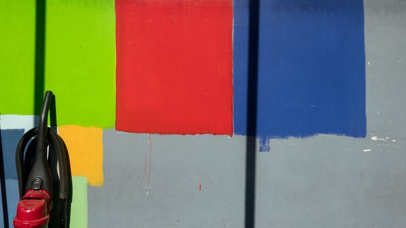 Empty storefront with paint swatches and vacuum cleaner