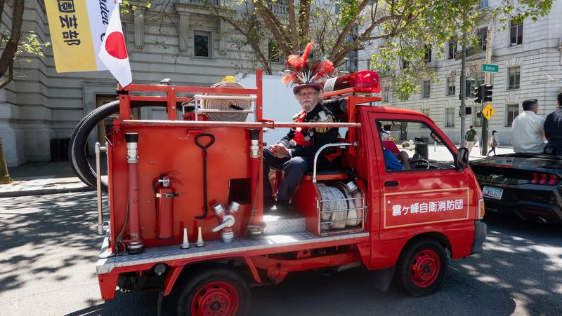 Emperor Norton on the back of a mini Japanese Firetruck