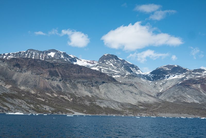 The Ilimaussaq complex from Tunulliarfik. The dark basaltic roof to the intrusion can be seen in the central peak.
