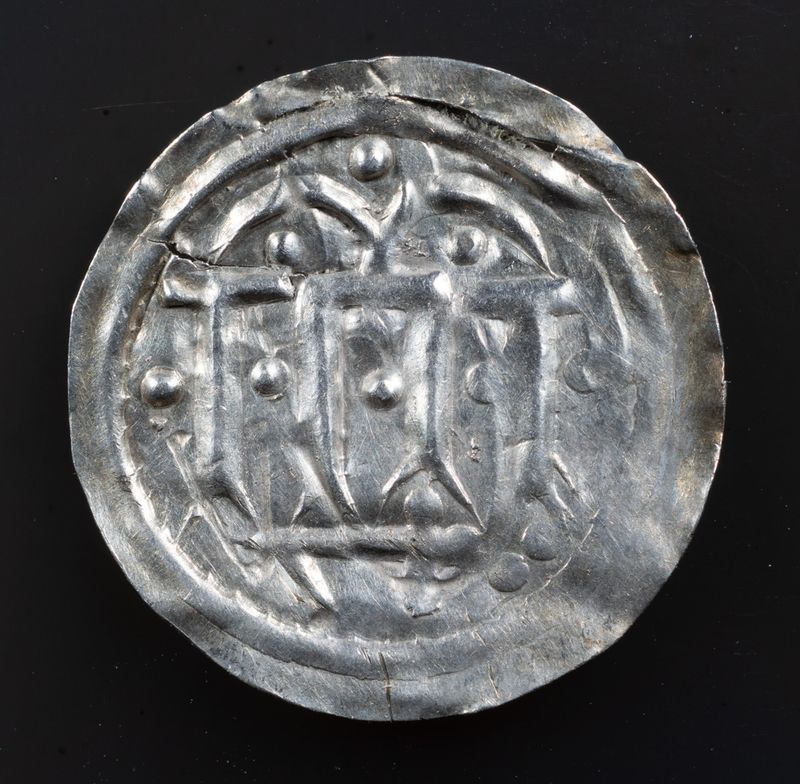 Early Danish semibracteate, 10th century, thought to be Hedeby mint. Hauberg 1, KG9, after Carolingian Dorestat denier