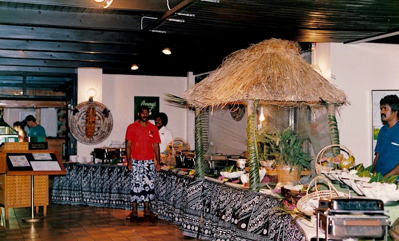 the native Fijian head cook proudly presenting local dishes