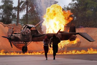 Indy and Marion running from the explosion