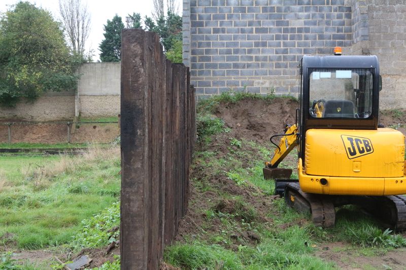 Erecting fence between ranges, this one is made from old railway sleepers