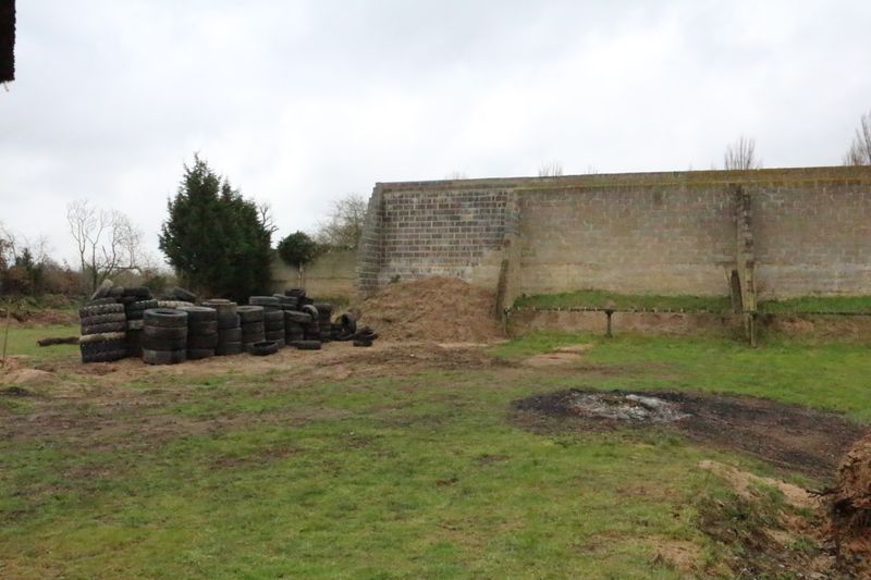 Old tyres were used to make a fence between ranges. Was a failure, was removed