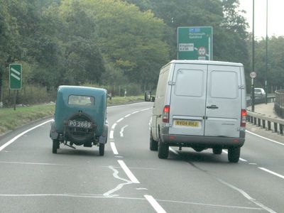Look at the wheels on the car compared to the van