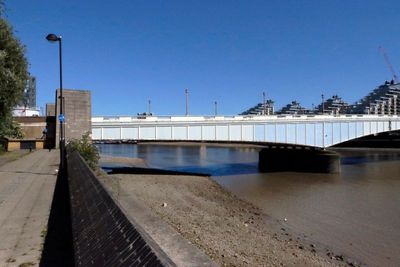 Wandsworth Bridge, low tide, blue sky