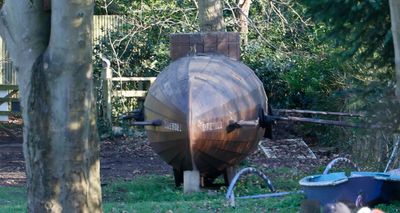 Walking along a narrow footpath with my wife, there was a wooden submarine in a field