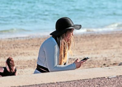 A young girl looking at her phone, dont see that very often