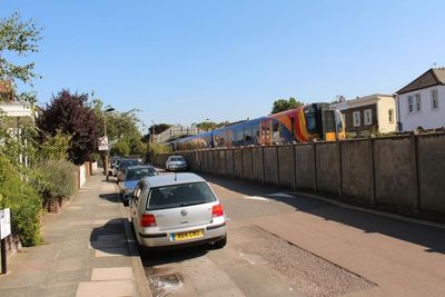 The trains are very close to the houses