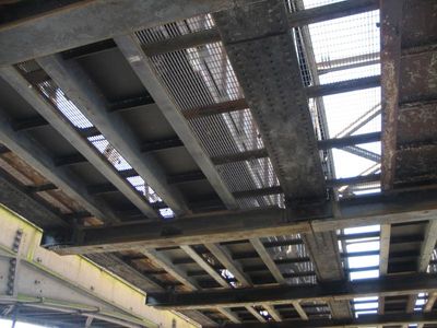 Looking up at train from under bridge