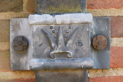 Lead brackets holding the drainpipes to the wall