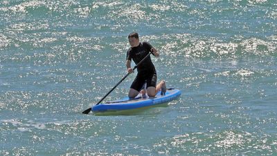 Paddle boarding in a choppy sea