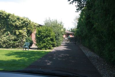 The road runs from the front gate down to the river