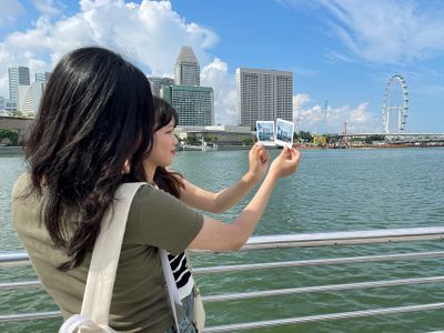 Girls with photos of Marina Bay Sands Hotel