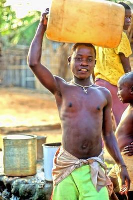 Carrying Water From the Well At Sunset 