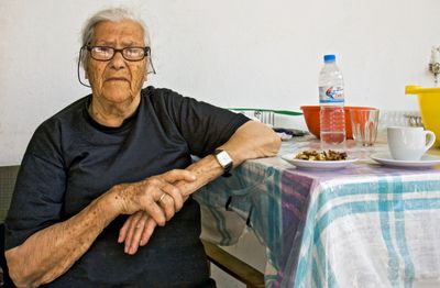 Woman serving her guest coffee and walnuts
