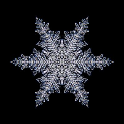 Kaleidoscopic snowflake created with a real natural frost structure