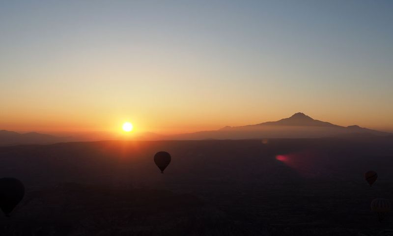 Balloon rising at sunrise
