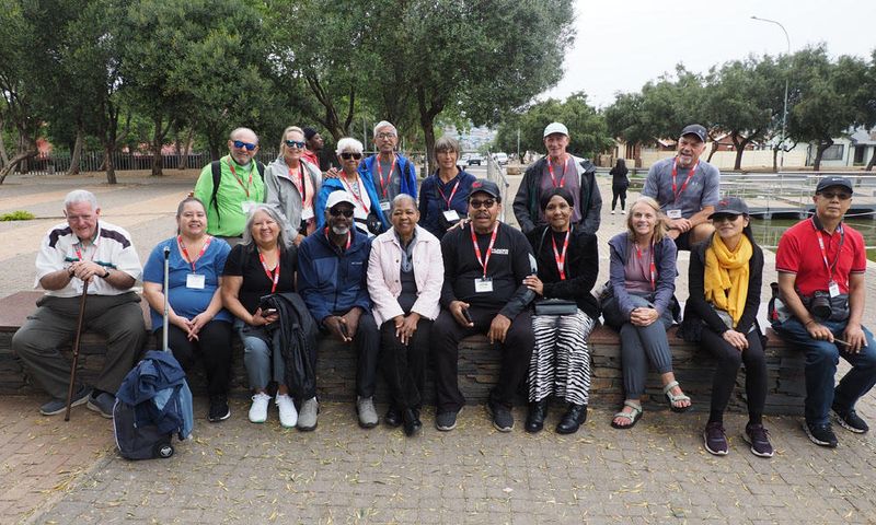 The group posing with Mama Antionette in Soweto