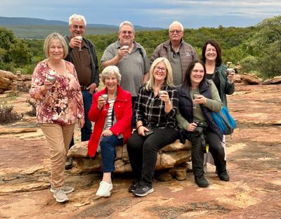 The group drinking South African champagne on top of a mountain watching sunset.