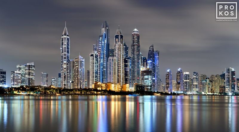 Cityscape photography of the  Dubai Marina skyline at night by master fine art photographer Andrew Prokos. Composed of multiple high-definition long-exposure images meticulously merged to create large-scale prints up to 120 inches in width. Please inquire regarding additional print sizes. Andrew's Dubai fine art photography has won numerous international awards and has been widely published at CNN, Harper's Bazaar, DesignBoom, and other publications. Artwork ships direct from the artist's New York fine art photography gallery.