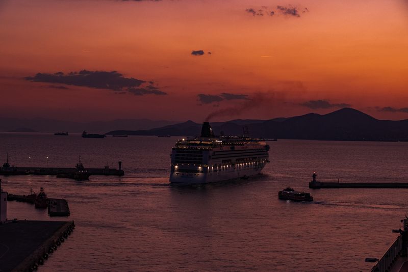 CRUISE SHIP LEAVING  THE PORT AT SUNSET