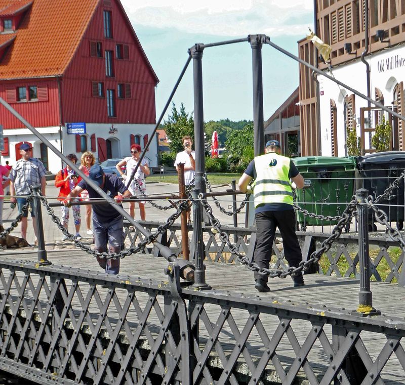 Men hand-cranking 1855 bridge in Klaipeda for boats to pass through
