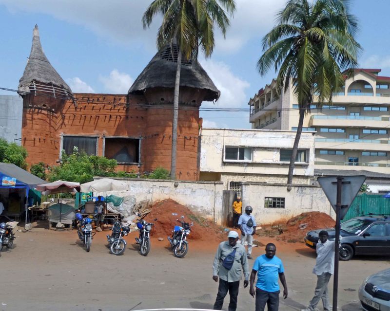 Togo tradtional archicture next to modern building in Loma, Togo.JPG