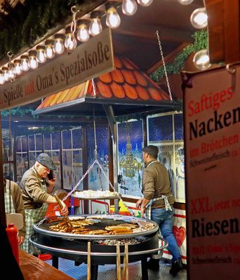 Grilling meat at Kaiser Wilhelm Memorial Church Christmas Market