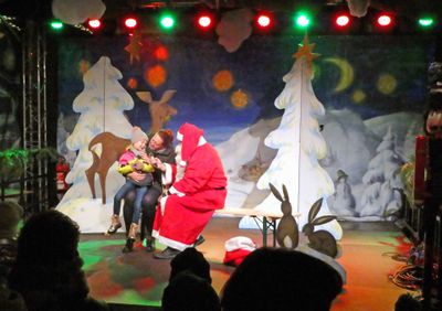 Santa at Meissen Christmas Market getting a girl to sing O'Tannenbaum