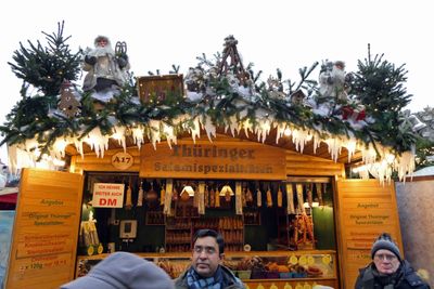 The sign on the left loosely translated says 'I continue to accept Deutsche Marks'