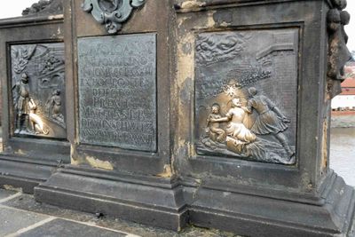 Base of the statue of John of Nepomuk is rubbed by people for good luck