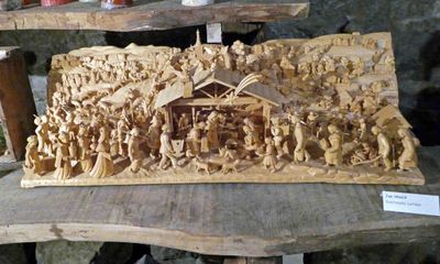 Very busy nativity appears to be carved from a single piece of wood