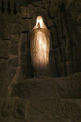 Light Rock Salt statue of Mary is next to monument to Pope John Paul II in St. Kinga's Chapel