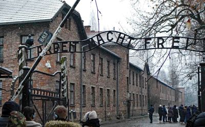 Sign over the entrance to Auschwitz is translated as 'Work Sets You Free'