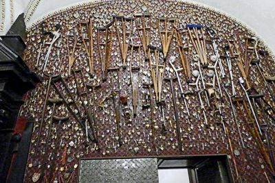 Crutches and walking sticks left by those who have been healed after prayer in the presence of the icon of the Black Madon