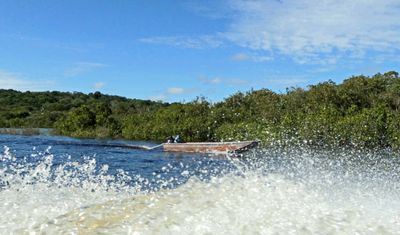 Speeding past a local boat on Rio Negro