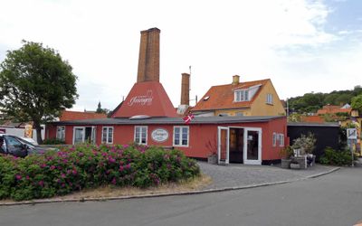 Houses with tall chimneys in the fishing village of Gudhjem, Denmark are now (or were previously) used to smoke fish